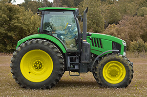 Tractor verde en movimiento sobre un terreno